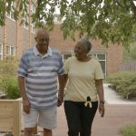 couple enjoying a leisurely stroll walking hand in hand in good health
